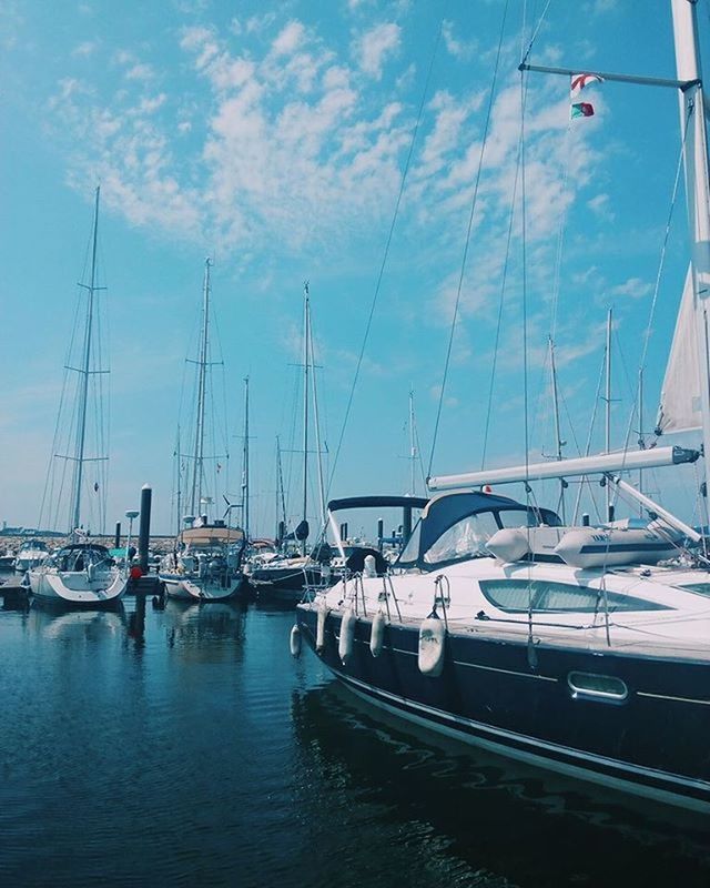 transportation, nautical vessel, mode of transport, moored, boat, mast, water, sailboat, harbor, sky, travel, sea, yacht, car, in a row, cloud - sky, day, waterfront, outdoors, no people