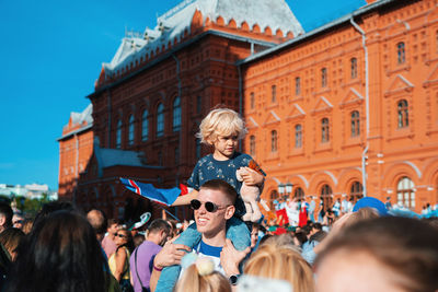 Group of people against buildings in city