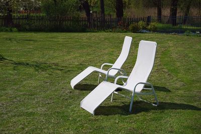 Empty chair on grassy field