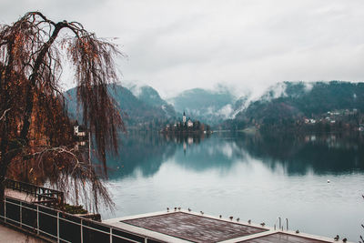 Mid distance view of church in lake bled against mountains