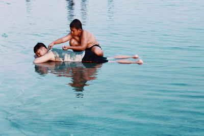 Brothers playing in lake