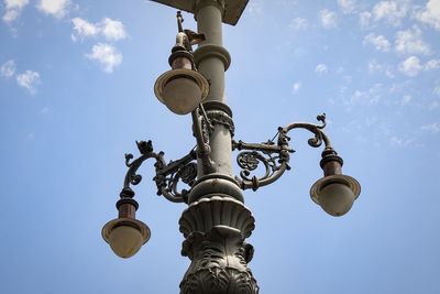 Low angle view of lamp post against sky during sunny day