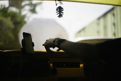 Close-up of man holding glass car