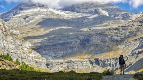 Man standing on rock with mountain in background