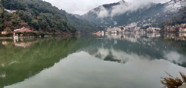 Scenic view of lake by trees and mountains