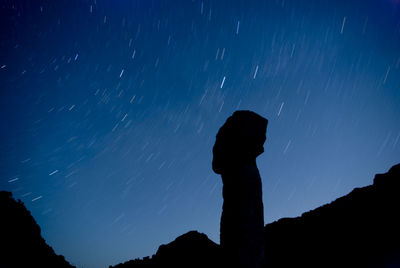 Silhouette woman against sky at night