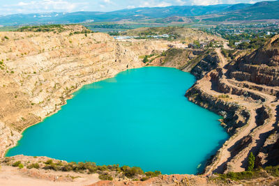 Russia, crimea. turquoise heart-shaped lake. kadykovsky quarry. tourism in summer. in the mountains.