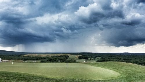 Scenic view of landscape against cloudy sky