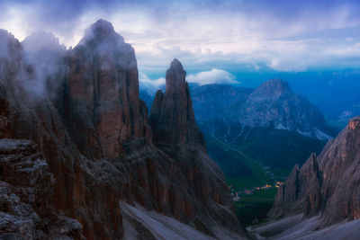 Scenic view of mountains against cloudy sky