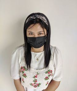 Portrait of beautiful young woman against white background