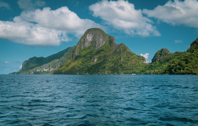 El nido limestone karst mountain peaks in blue ocean boat cruise view.