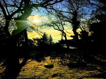 Silhouette trees against sky during sunset