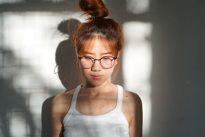 Portrait of young woman wearing eyeglasses