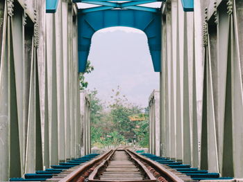 Railroad tracks amidst buildings against sky