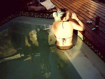 Woman standing by swimming pool