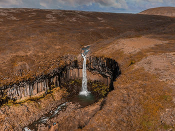 Aerial view of the svartifoss waterfall surrounded by basalt columns