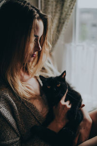 Close-up of young woman sitting at home