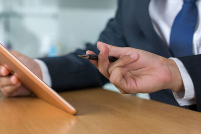 Midsection of man working on table