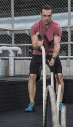 Man training at rooftop gym in bangkok