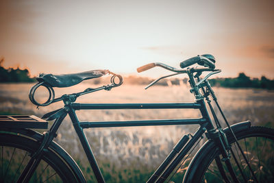 Close-up of bicycle parked on street against sky