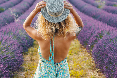 Rear view of woman standing on field