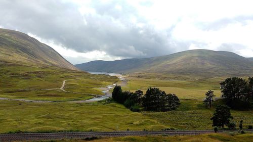 Scenic view of mountains against cloudy sky