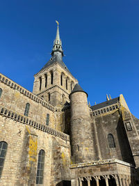 Low angle view of historic castle. mont saint-michel on the islands of normandy, france.