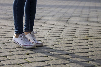 Low section view of woman standing on walkway