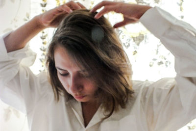 Close-up portrait of a young woman at home