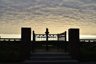 Silhouette bridge against sky during sunset