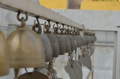 Close-up of metal hanging against wall