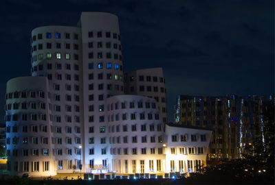 Buildings in city at night