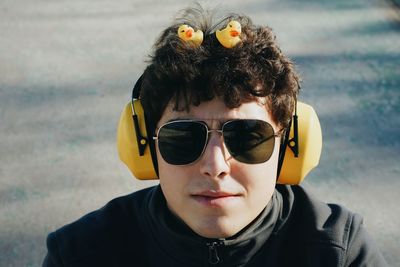 Portrait of young man wearing sunglasses standing outdoors