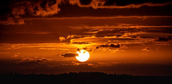 Scenic view of silhouette land against sky during sunset