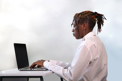 Side view of woman using mobile phone