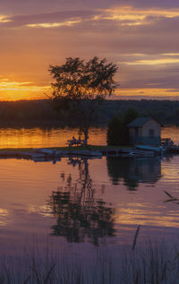 Scenic view of lake against romantic sky at sunset