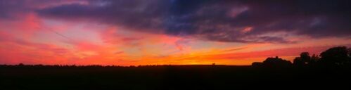 Scenic view of landscape against sky at sunset