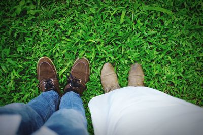 Low section of men standing on grass