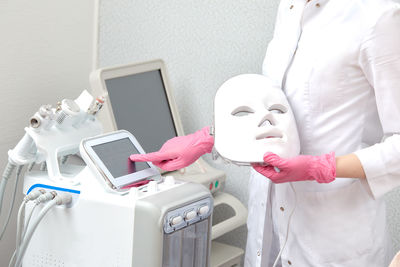 Midsection of woman using mobile phone