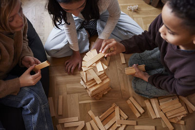 Children playing jenga at home