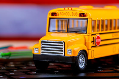 Close-up of toy bus on computer keyboard