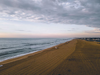 Scenic view of beach against sky during sunset