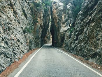 Road amidst rocks against mountain