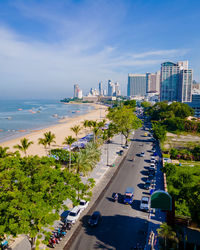 High angle view of city by sea against sky