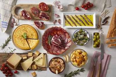 We love spanish tapas. a table with typical spanish food seen from above. 