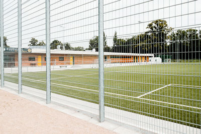 Empty soccer field seen through fence