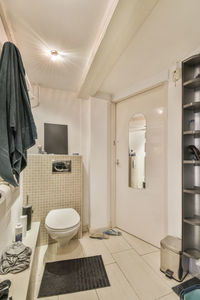 Rear view of woman sitting in bathroom