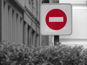 Close-up of road sign against built structure