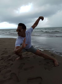 Full length of man on beach against sky