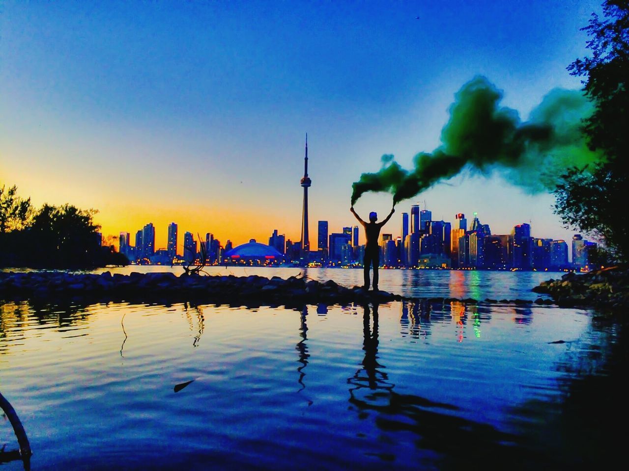 water, building exterior, architecture, built structure, sunset, reflection, waterfront, city, tower, clear sky, sky, illuminated, river, travel destinations, famous place, blue, tall - high, dusk, communications tower, capital cities